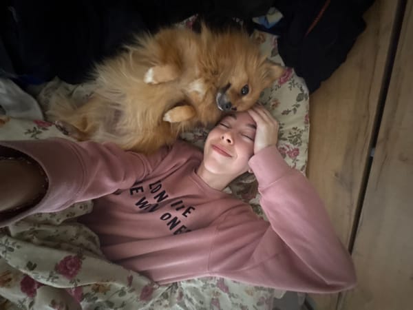Person and Pomeranian share quiet morning moment in Sofia