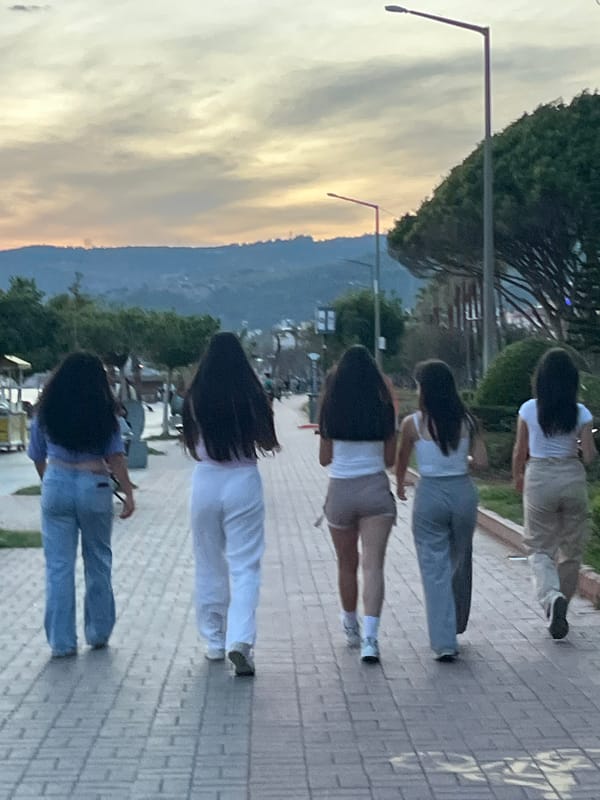 Five women walk together along Alanya coastline