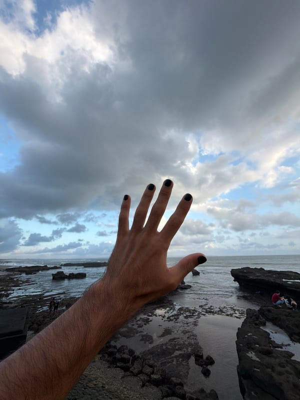 Person photographed in artistic hand poses in North Kuta