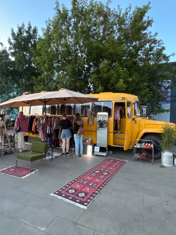 Pop-up clothing market by a converted yellow bus, Saint Petersburg