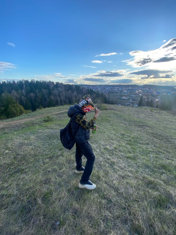 Person observed on hillside overlooking town during afternoon hours
