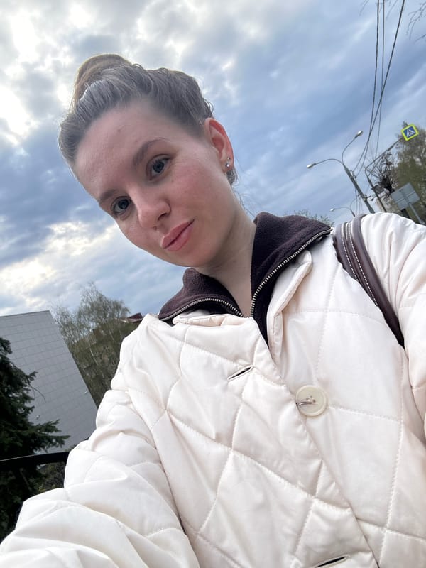Woman takes selfie in quilted jacket in Klin, Russia