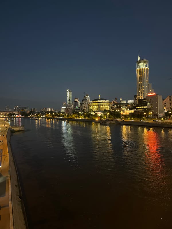 Moscow River skyline lit up at night, bridge and towers glowing
