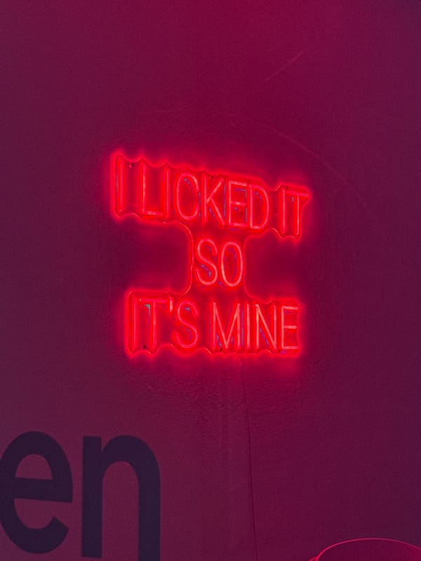 Red neon sign with partial text observed in Munich