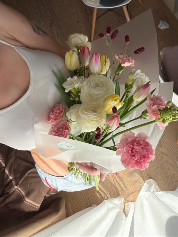 Woman with flowers, playful cat documented in Belgrade home