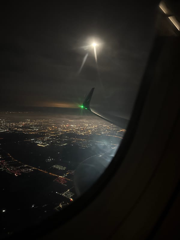 Passenger captures nighttime aerial view over Daxing District, China