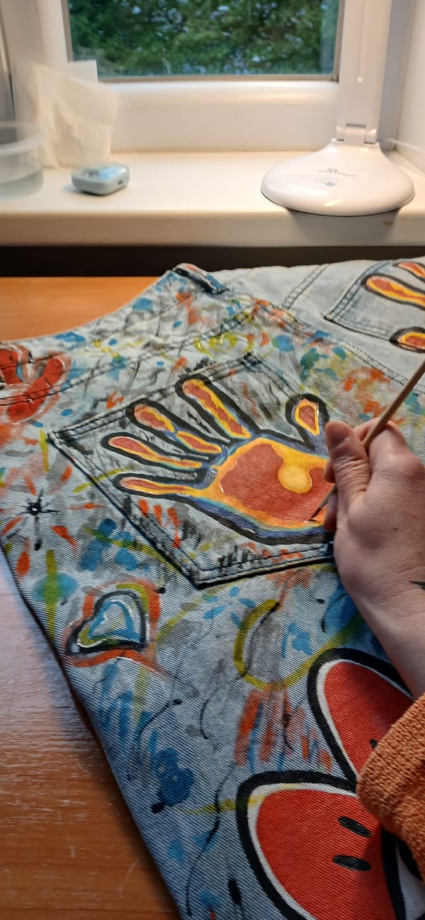 Artist customizes clothing with colorful paint designs in Riga