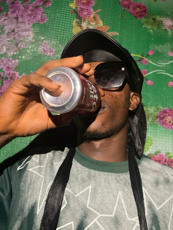 Person poses with various objects during photoshoot in Nigeria