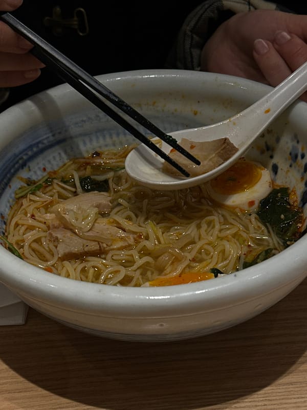 Person enjoys ramen meal in Shibuya district