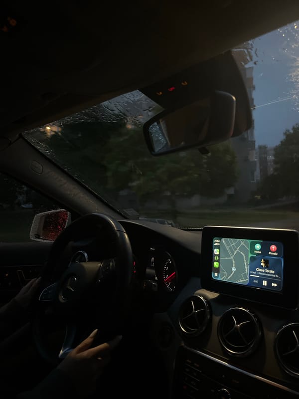 Driver navigates rainy evening streets in Blagoevgrad, Bulgaria
