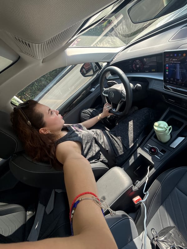 Woman takes selfie in car with Spanish navigation display