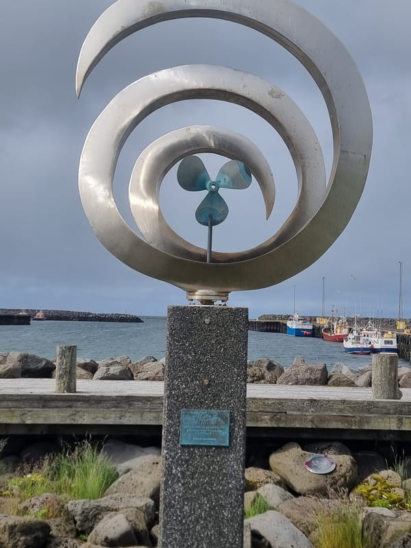 Sandgerði landmarks: metal sculpture and yellow antenna tower