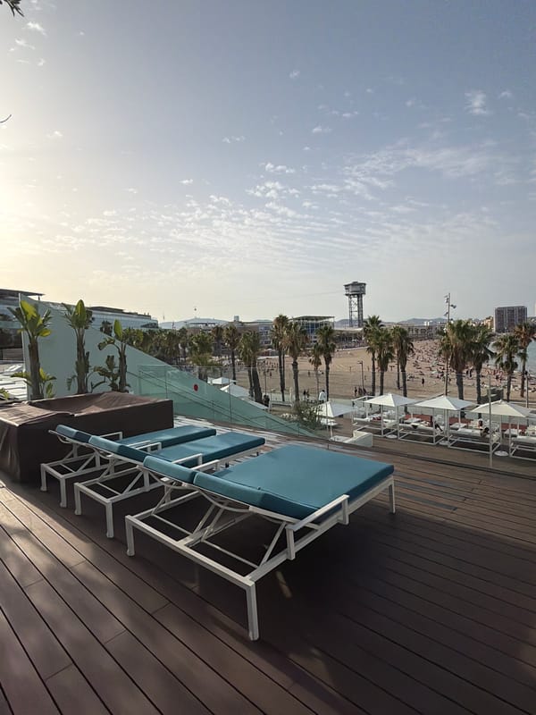 Rooftop terrace views over a packed Barceloneta Beach