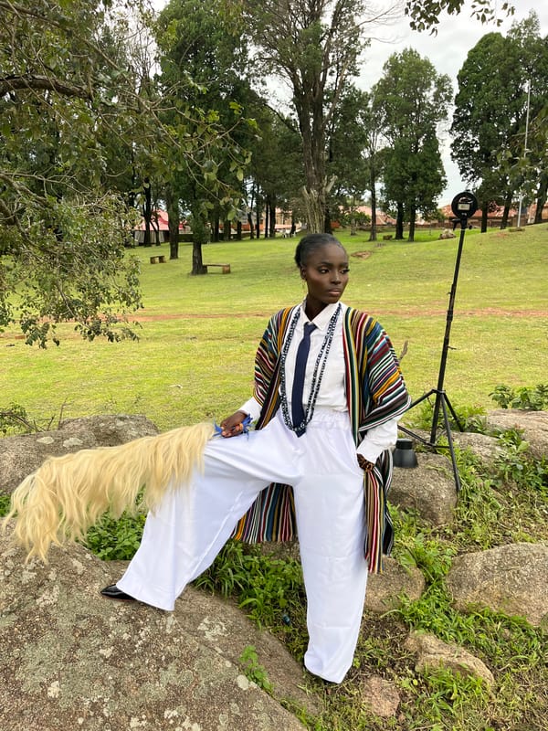Outdoor fashion shoot with traditional attire on rocky grass