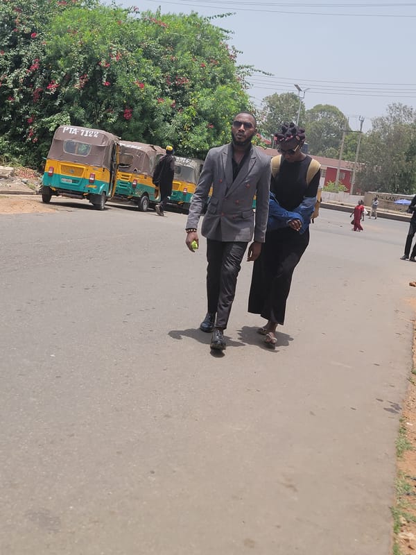 Two men walk along road in Jos, Nigeria