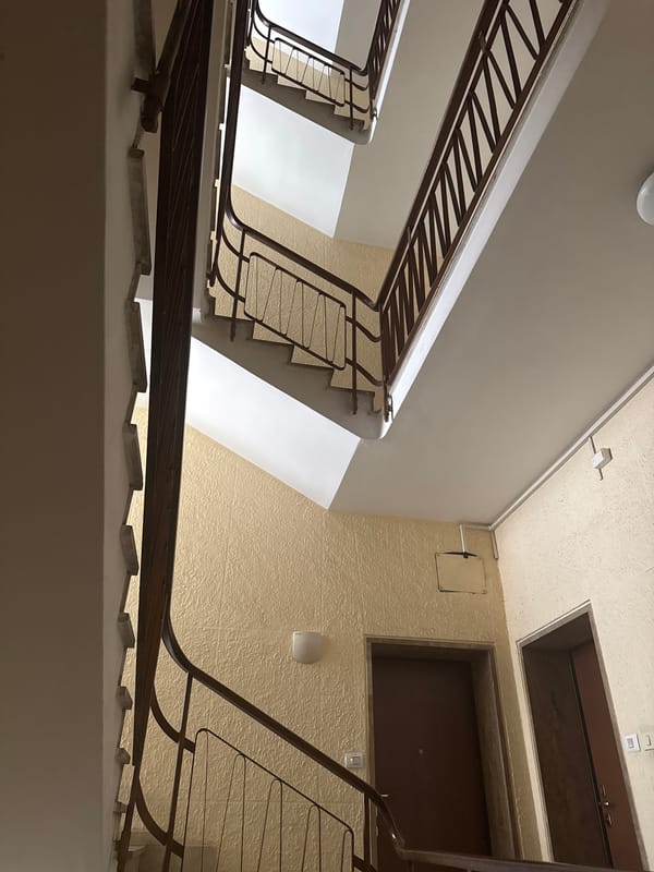Interior stairwell with metal railings in Como apartment building