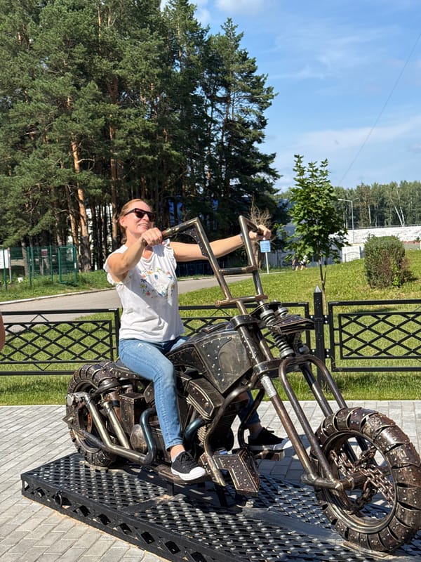 Posing on a metal motorcycle sculpture in Chaikovsky