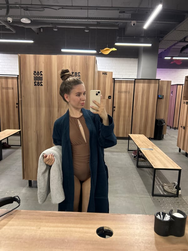 Woman takes mirror selfie in changing room facility