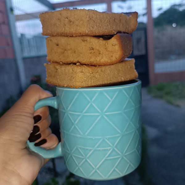 Person displays baked goods on decorative mug in Venezuela