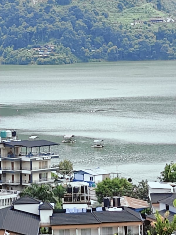 Phewa Lake shoreline in Pokhara on a cloudy morning