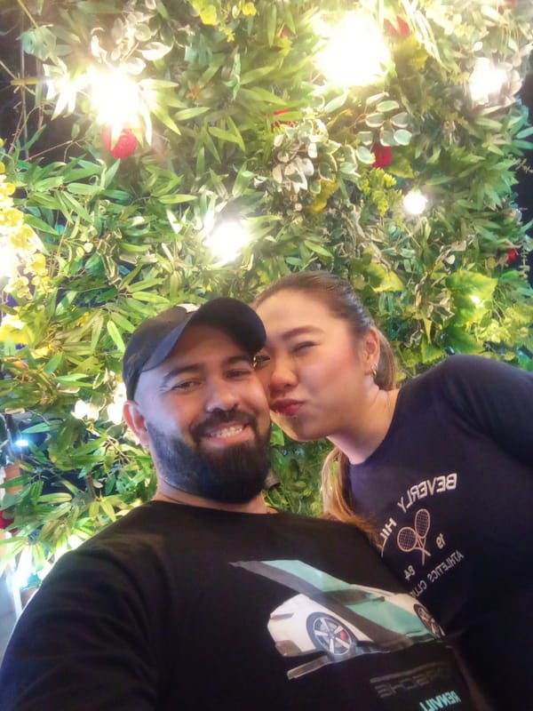 Nighttime gathering at illuminated Valencia plaza with ice cream vendor