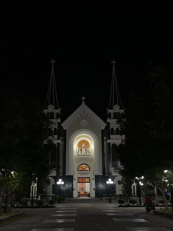 Nha Trang at night: cathedral spires, lit trees, and street life
