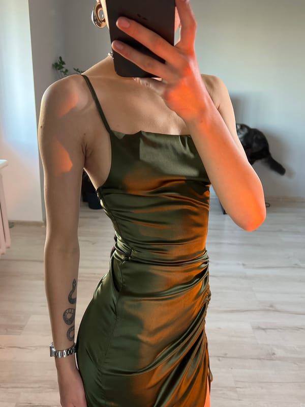 Woman Takes Mirror Selfies in Green Dress in Ternopil