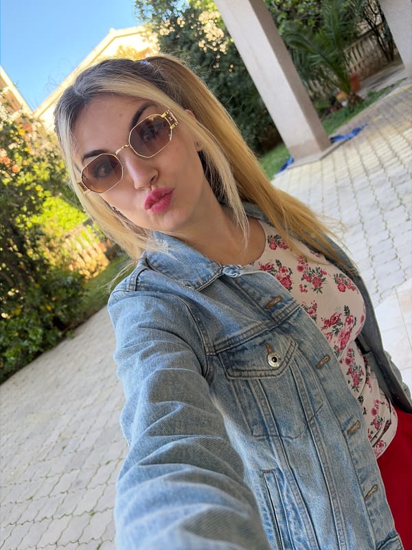 Woman styling hair in Budva bathroom Thursday morning