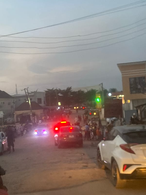 Evening traffic flows through Abuja streets at dusk