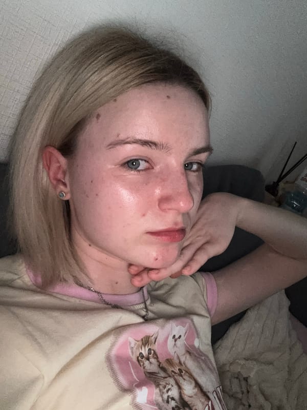 Person resting indoors wearing 'LOVELY LIFE' shirt captured close-up