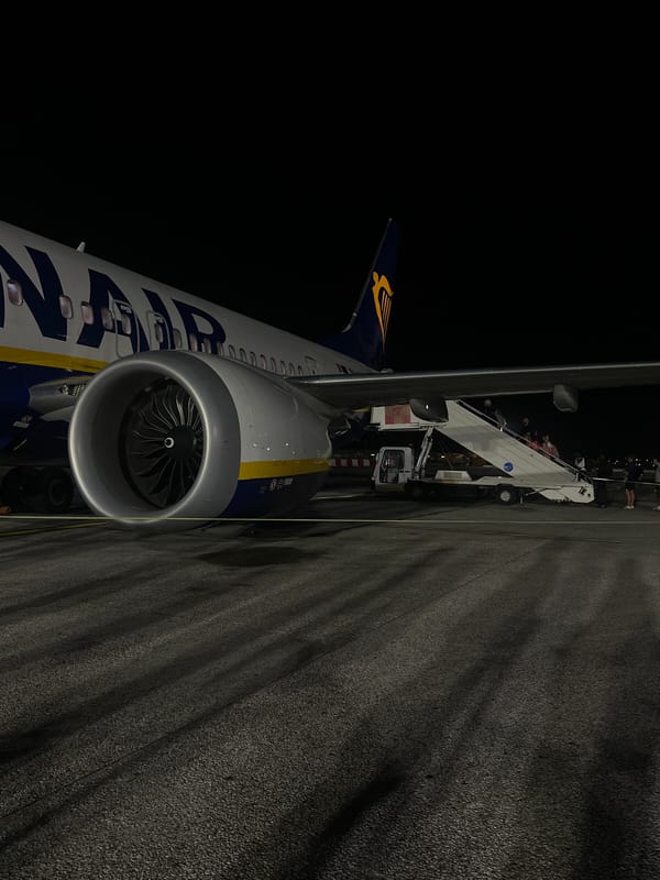Young adults gather at Pisa airport during evening flight operations