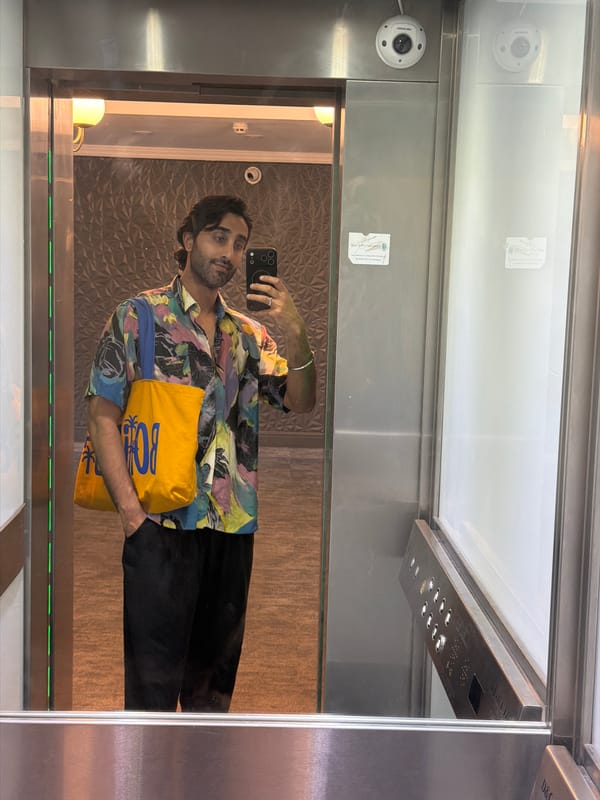 Elevator mirror selfie in London, colorful patterned shirt.