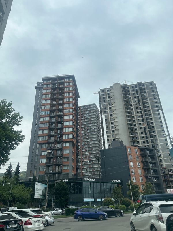 Tbilisi street shows residential towers and active construction site