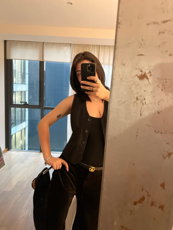 Mirror selfie in a Mexico City apartment with a garden view