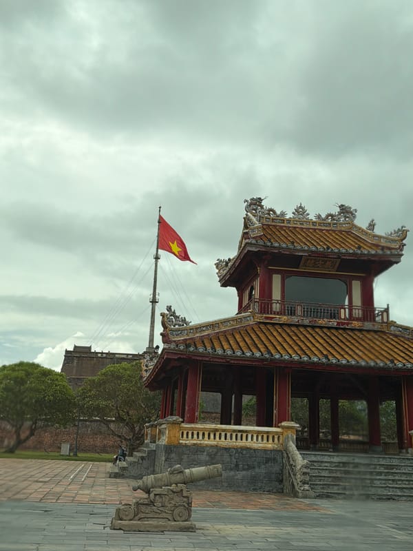 Morning traffic flows past Huế's imperial citadel walls