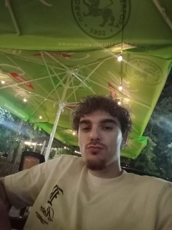 Young men gather at nighttime cafe in Parvomay, Bulgaria