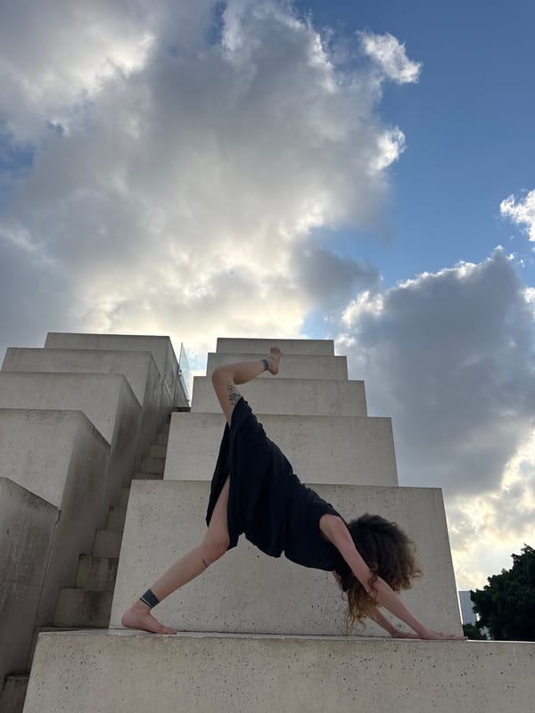 Yoga and movement practice across a Tel Aviv concrete plaza