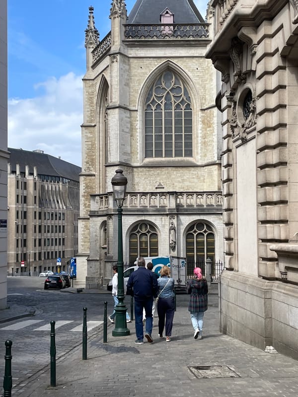Tourist documents Gothic cathedral and Brussels streetscapes during walking tour