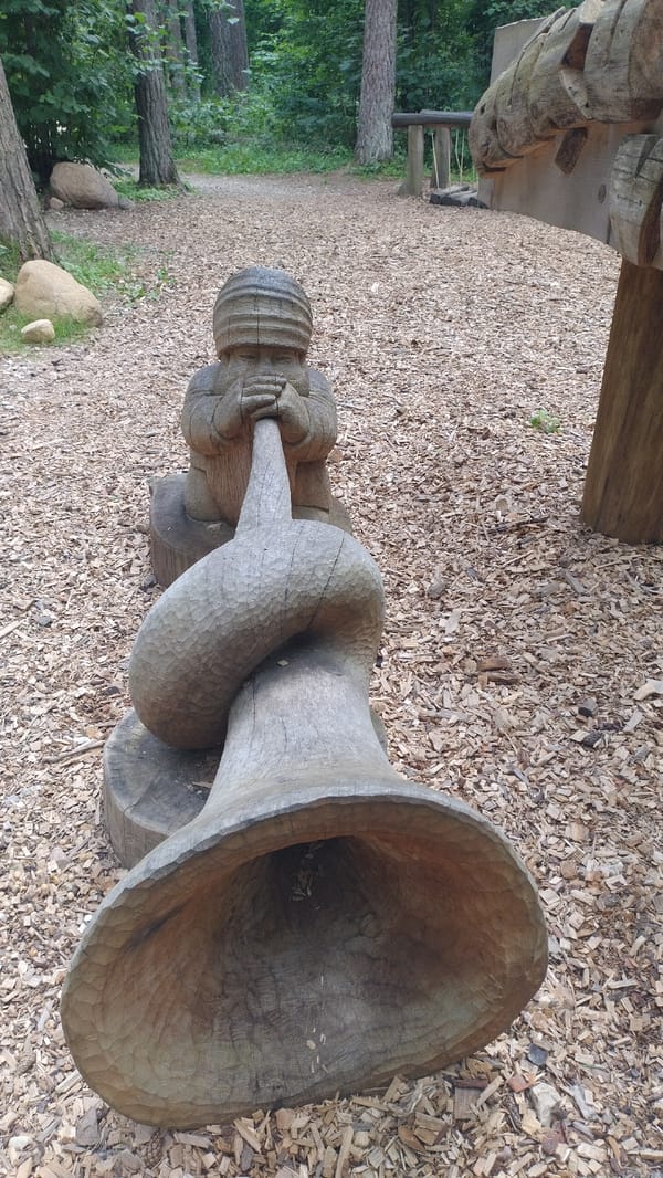 Carved wooden gnomes in Tērvete Nature Park, Latvia