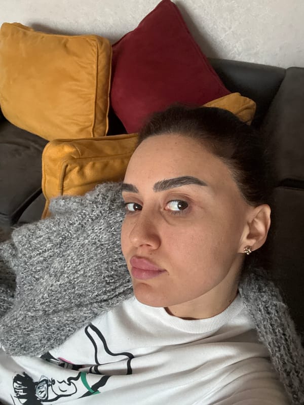 Woman rests on sofa indoors in Tbilisi