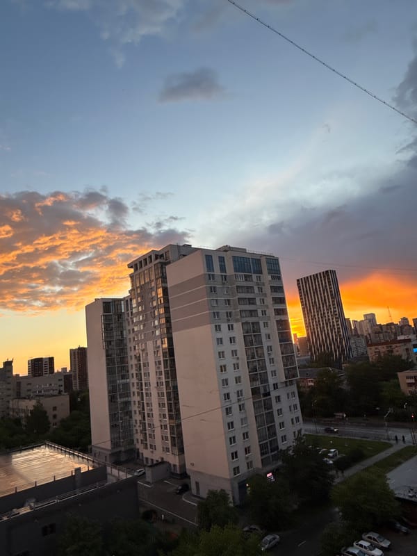 Dramatic sunset illuminates Yekaterinburg skyline amid cloudy evening
