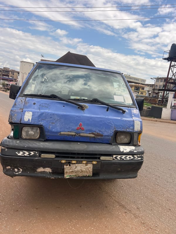 Street-side fueling and a parked van in Nkpor, Nigeria