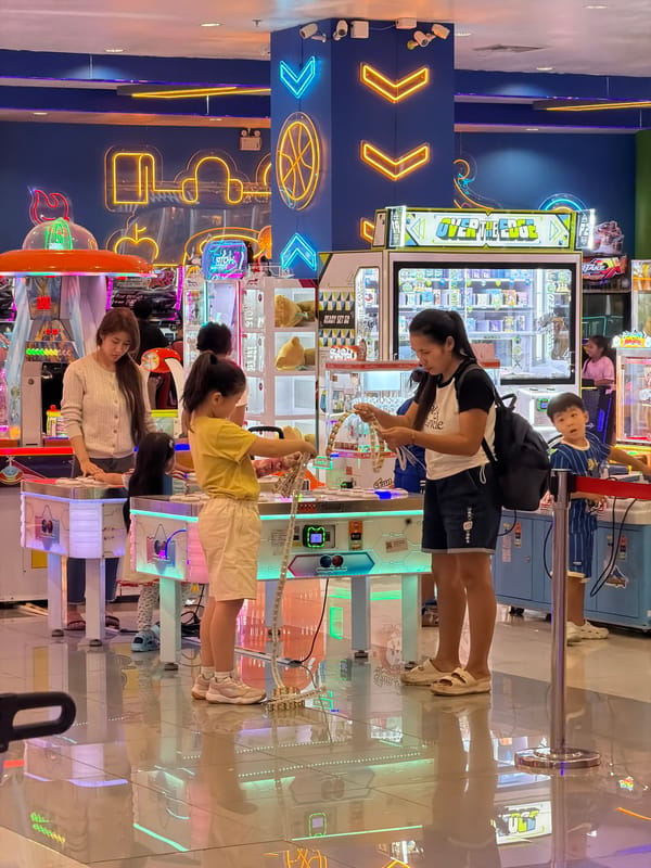 Family group enjoys arcade games in Chiang Mai