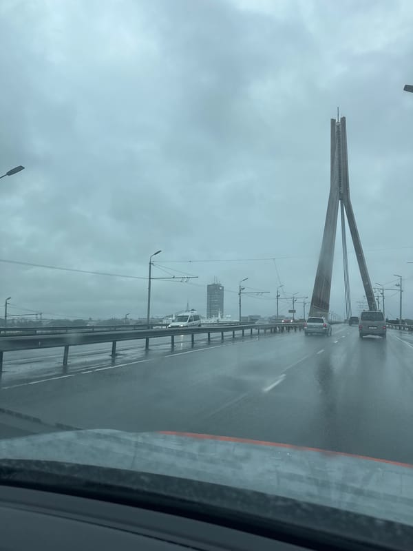 Crossing a rain-soaked cable-stayed bridge in Riga