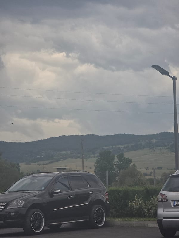 Overcast morning captured with parked cars, mountains in Kraishte