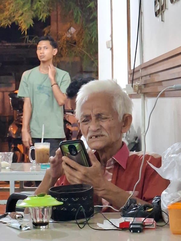 Elderly man enjoys coffee break at Lhokseumawe cafe