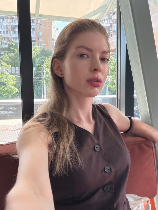 Woman takes indoor selfie in Khimki with cityscape backdrop