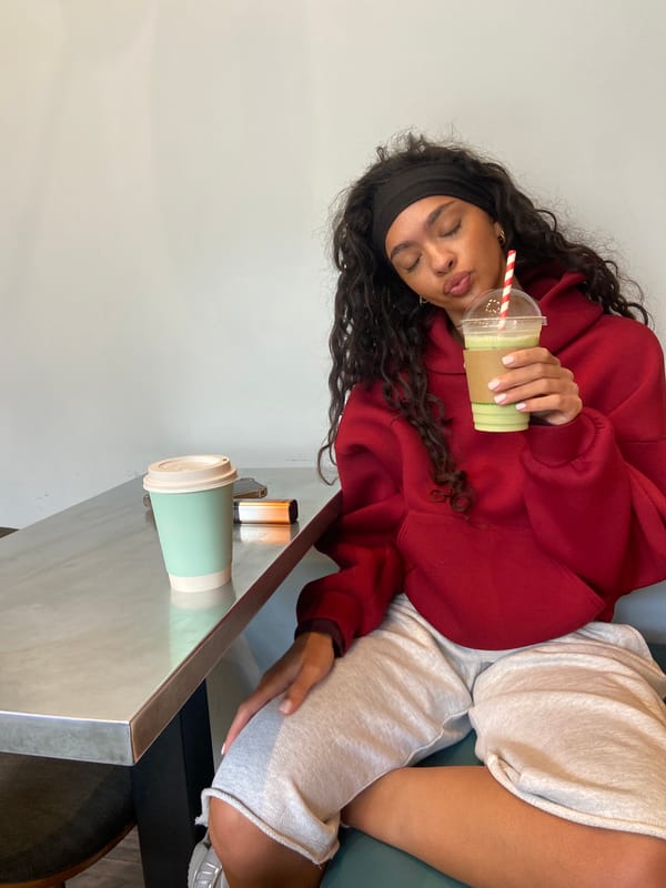 Woman enjoys green smoothie at London table