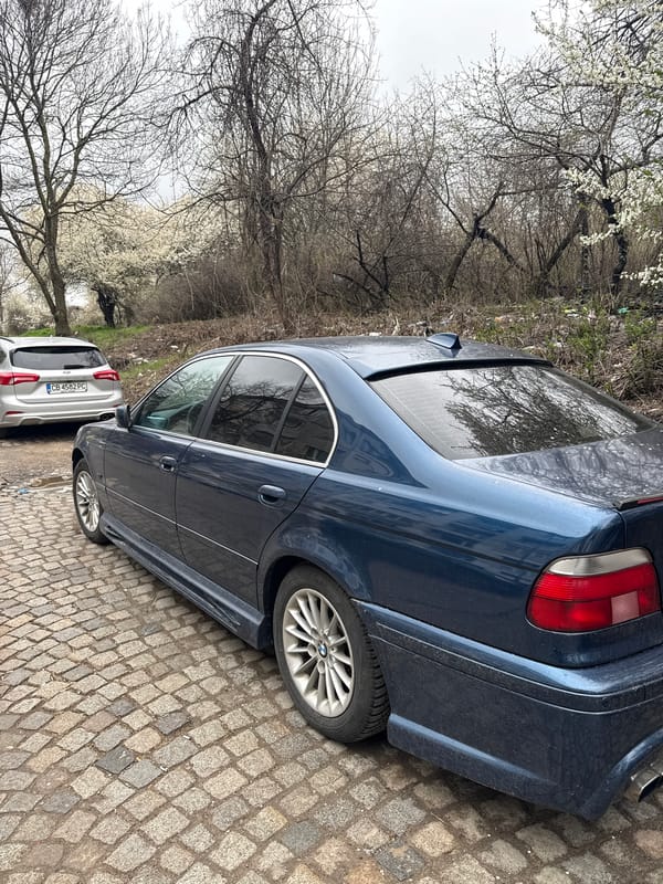 Blue BMW parked on cobblestone street in Sofia