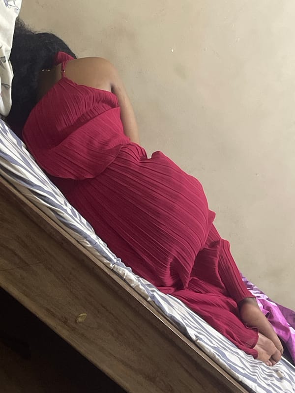 Resting on a striped bed in a Dar es Salaam bedroom